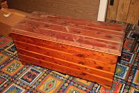 Closed cedar chest showing the wood grain and surface wear.