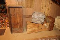 All five wooden crates arranged on floor showing variety of sizes and vintage markings