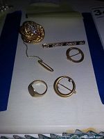 Overview of all six 10K gold jewelry items laid flat