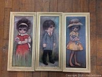 Set of three vintage Ozz Franco framed prints laid side-by-side on wooden floor.
