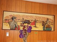 Wide view of bullfight 3D mixed media wall art against wood panel wall with flowers in foreground