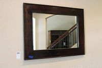Full front view of the rectangular mirror hanging on wall