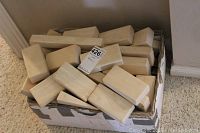 Box filled with plain light wooden rectangular blocks, showing quantity and general condition.