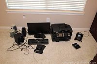 Wide view of the lot showing monitor, keyboard, mouse and pad, speakers, printer, router and a DVD player.