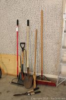 Full view of garden rake, shovels, brooms and part of ladder