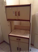 Full view of microwave cabinet showing upper double-door storage, middle countertop, and lower drawer and cabinet storage.