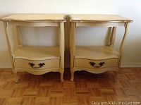 Front view of two matching yellow Kroehler end tables with scalloped edges, a drawer each, and open lower shelf.