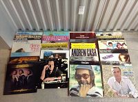 Six LP album spines and front covers visible: Bay City Rollers, Shirley Bassey’s Greatest Hits, Diana Ross, motion picture themes compilation, Andrew Cash