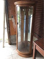 Full frontal view showing curved glass door, oak finish and overall height