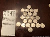 Top view showing arrangement of vintage dimes with MaxSold numbered card for lot identification.