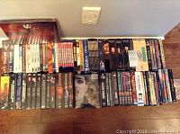 Photo showing a large collection of DVDs lined up, including TV show seasons and movie collections.
