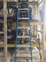 Full view of blue Werner folding ladder showing steps and frame.