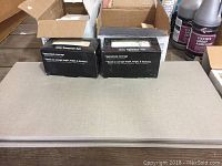Ceramic tiles and tile boxes stacked, labeled Ivory Travertine 3x6