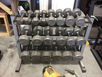 Front view of three-tier rack loaded with dumbbells
