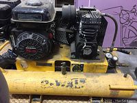 Left-side overview of the yellow compressor tank with mounted Honda engine and DeWalt pump