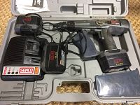 Photo showing Senco DS202 cordless screwdriver with two batteries, charger, carrying case, and manual inside the molded plastic case.