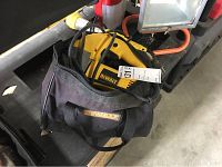 Photo of DeWalt branded black carrying bag containing jigsaw and power cord.