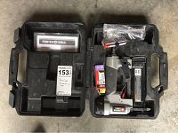 Porter Cable finish nailer, carrying case, instruction manual, and nail boxes inside the case on concrete floor.