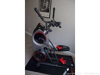 Side-angle view showing overall frame, flywheel housing and pedals