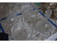 Four-piece Waterford crystal set on table, includes decanter with stopper, candy dish, fruit bowl, and pitcher; clear cut crystal pattern visible.