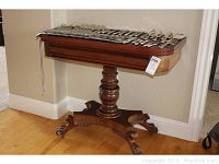 Full view of table showing tilt-top surface and pedestal base