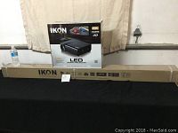 Projector box and long narrow screen box displayed side by side on table