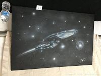 Print of Star Trek USS Enterprise in flight in space with starry background and nebulae.