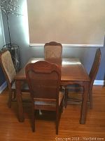 Front view of oak dining table with chairs