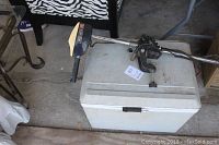 White Koolatron cooler with Minn Kota trolling motor resting on it, showing overall items and scale.