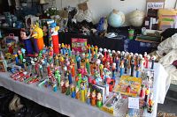 Table overview showing about 60+ loose PEZ dispensers across multiple themes