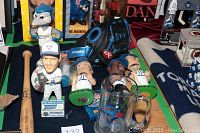 Wide view showing glass stein, several Toronto Blue Jays bobblehead dolls, Rawlings baseball glove, wooden baseball bat, baseball, and deck of playing cards