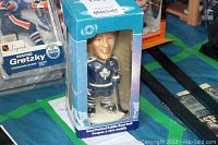 Darryl Sittler bobblehead figure in original blue box with window showing figure wearing blue Toronto Maple Leafs uniform with captain 'C' and holding hockey stick.