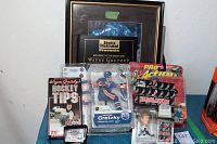 Full view of collection including boxed Wayne Gretzky action figure, framed plaque, VHS tape, bobblehead figure and coin box.