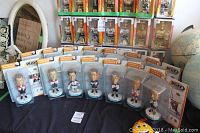 Fifteen unopened NHL bobblehead figures displayed on a table, each in original Upper Deck packaging, showing front view of multiple players.