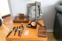 Overview of all included items on a wooden table near wall and sofa.