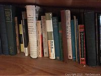 Shelf with various music and historically themed books including titles on Mozart and symphony orchestras