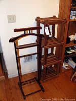 Two wooden racks shown together: a valet stand with hanger and horizontal bars and a shoe rack with three slatted shelves