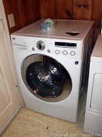 Full view of LG front-load washer showing door, control panel, and side profile.