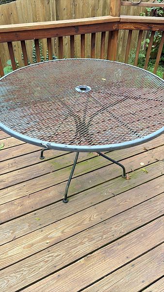 Wrought iron patio table with four chairs | Maxsold